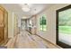A spacious kitchen features modern appliances, light gray cabinets, quartz countertops, and a view to the backyard at 125 Selena Ct, Fayetteville, GA 30215