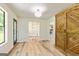 Bright living room with wood-look floors, updated lighting, and an opening to a stone fireplace in an adjacent room at 125 Selena Ct, Fayetteville, GA 30215