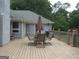 Outdoor back deck with patio table and chairs for outside entertainment at 1455 River Cove Rd, Social Circle, GA 30025