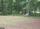 Backyard swing set in a verdant, wooded lot at 1455 River Cove Rd, Social Circle, GA 30025