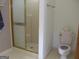 Practical bathroom with a shower stall and toilet in a well-lit space at 1455 River Cove Rd, Social Circle, GA 30025