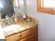 Bathroom with wood cabinets, granite counters, and white sink, offering a blend of functionality and style at 1455 River Cove Rd, Social Circle, GA 30025