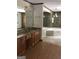 Bathroom featuring a double sink vanity and soaking tub with a glass shower enclosure, offering a spa-like feel at 1455 River Cove Rd, Social Circle, GA 30025