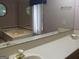Double sinks in a spacious bathroom featuring a soaking tub and natural light at 1455 River Cove Rd, Social Circle, GA 30025