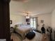Inviting bedroom with a ceiling fan, soft lighting, and cozy furnishings at 1455 River Cove Rd, Social Circle, GA 30025
