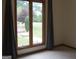 Bedroom with large windows overlooking the landscaped backyard with a lawn and a lush green garden at 1455 River Cove Rd, Social Circle, GA 30025
