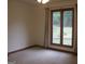 Bright bedroom with a large double window offering natural light and views of the outdoor landscape at 1455 River Cove Rd, Social Circle, GA 30025