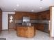 Open kitchen with a large island, stainless steel appliances, and tile flooring at 1455 River Cove Rd, Social Circle, GA 30025