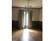 Dining room with a modern chandelier above the table set in front of large window at 1455 River Cove Rd, Social Circle, GA 30025