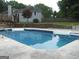 Clean in-ground pool with concrete surround, perfect for summer fun at 1455 River Cove Rd, Social Circle, GA 30025