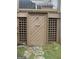 Outdoor shower enclosure made of wood and decorative lattice with a stone paver base and plumbing at 1455 River Cove Rd, Social Circle, GA 30025