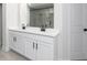 Modern bathroom showcases a glass shower and double sink vanity with black hardware and white countertops at 676 Cantrell Drive, Dallas, GA 30157