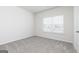 Carpeted bedroom with a window and neutral wall color at 280 Limestone Circle, Conyers, GA 30013