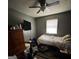 Bedroom with carpet, ceiling fan, and a window allowing for natural light at 6884 Red Maple Ct, Rex, GA 30273