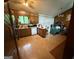 An outdated kitchen featuring wooden cabinetry, dated countertops and wood-look flooring at 6884 Red Maple Ct, Rex, GA 30273