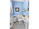 Cozy blue and white bathroom with patterned flooring and ample lighting at 201 Greensprings Dr, Palmetto, GA 30268
