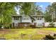 Charming two-story home with light blue siding, brick accents, and a lush green lawn at 201 Greensprings Dr, Palmetto, GA 30268