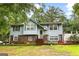 Charming two-story home with light blue siding, brick accents, and a lush green lawn at 201 Greensprings Dr, Palmetto, GA 30268