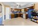 Well-lit kitchen featuring blue accents, wooden cabinets and modern appliances at 201 Greensprings Dr, Palmetto, GA 30268