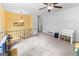 Bright living room with neutral carpet, a ceiling fan, and a staircase at 201 Greensprings Dr, Palmetto, GA 30268