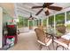 Bright sunroom with screened windows, ceiling fans, and a dining set overlooking the yard at 201 Greensprings Dr, Palmetto, GA 30268