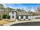 Stunning two-story home features a well-manicured lawn and a welcoming front entrance and a lush backdrop of mature trees at 103 Sandtrap Rdg, Peachtree City, GA 30269