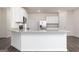 Bright kitchen featuring granite countertops, modern fixtures, white cabinets, and stainless steel appliances, offering modern elegance at 1500 Big Bud Ln, Locust Grove, GA 30248