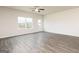 Spacious living area features wood-style flooring, bright natural light, and a view of the backyard, ideal for relaxation at 1500 Big Bud Ln, Locust Grove, GA 30248