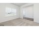 Bright living room features plush carpet, large window, neutral walls, and open doorway showcasing the home's interior at 1500 Big Bud Ln, Locust Grove, GA 30248
