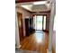 Elegant foyer with hardwood floors, decorative columns, and a tray ceiling, offering a grand entrance at 9361 Arbor Glenn Ct, Jonesboro, GA 30236