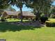 Beautifully landscaped front yard with mature trees and manicured shrubbery surrounding a brick home at 9361 Arbor Glenn Ct, Jonesboro, GA 30236