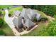 Rear aerial view displaying the home's roofline, a large deck, and surrounding trees at 185 Platinum Ridge Pt, Fayetteville, GA 30215