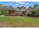 Expansive backyard with covered patio, deck, and lush green lawn at 185 Platinum Ridge Pt, Fayetteville, GA 30215