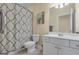 Bright bathroom with a shower with decorative curtain, white vanity, and neutral paint at 185 Platinum Ridge Pt, Fayetteville, GA 30215