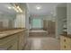 Open bathroom featuring a soaking tub, a walk-in shower, double vanity with stone countertops, and neutral flooring at 185 Platinum Ridge Pt, Fayetteville, GA 30215