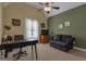 Inviting bedroom with a ceiling fan, a dark sofa, carpeted floors, and neutral wall color, creating a comfortable space at 185 Platinum Ridge Pt, Fayetteville, GA 30215