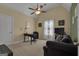 Cozy bedroom with a ceiling fan, a dark sofa, carpeted floors, and neutral wall color, providing a relaxing atmosphere at 185 Platinum Ridge Pt, Fayetteville, GA 30215
