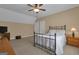 Traditional bedroom with a wrought iron bed frame, ceiling fan, and neutral-toned walls at 185 Platinum Ridge Pt, Fayetteville, GA 30215