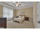 Comfortable bedroom with tray ceiling, neutral colors, and carpeted floor at 185 Platinum Ridge Pt, Fayetteville, GA 30215
