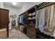 Walk-in closet with custom wood shelving and hanging racks, showcasing organized storage for clothing and accessories at 185 Platinum Ridge Pt, Fayetteville, GA 30215