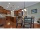 Dining area with hardwood floors and a glass table adjacent to kitchen at 185 Platinum Ridge Pt, Fayetteville, GA 30215