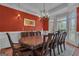 Elegant dining area featuring a large table, decorative lighting and wall accents at 185 Platinum Ridge Pt, Fayetteville, GA 30215