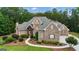Charming home with lush greenery, stone facade and manicured garden beds at 185 Platinum Ridge Pt, Fayetteville, GA 30215
