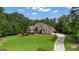Beautiful, stone-clad home with lush lawn and driveway on a sunny day at 185 Platinum Ridge Pt, Fayetteville, GA 30215