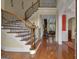 Grand foyer featuring a curved staircase, hardwood floors, and elegant trim at 185 Platinum Ridge Pt, Fayetteville, GA 30215