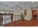 Second floor hallway with beautiful hardwood floors, coffered ceiling, and decorative railing overlooking the foyer at 185 Platinum Ridge Pt, Fayetteville, GA 30215
