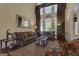Well-appointed living room with sofas, a mirror, and natural light from the tall windows at 185 Platinum Ridge Pt, Fayetteville, GA 30215