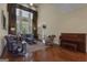Spacious living room featuring hardwood floors, tall windows and a decorative piano at 185 Platinum Ridge Pt, Fayetteville, GA 30215