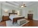Bright main bedroom with a decorative ceiling fan, hardwood floors, and soft natural light coming through the windows at 185 Platinum Ridge Pt, Fayetteville, GA 30215