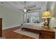 Spacious main bedroom with a trey ceiling, ceiling fan, hardwood floors and a large window with seating area at 185 Platinum Ridge Pt, Fayetteville, GA 30215